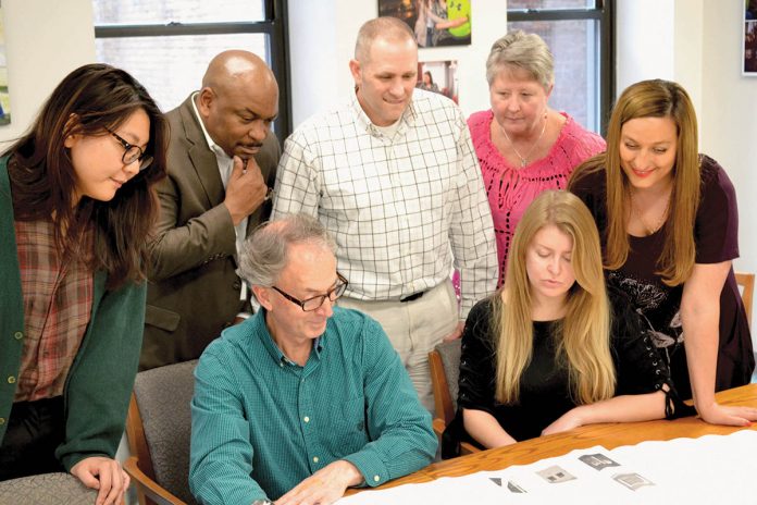 COLLABORATIVE TASK: Staff members from several R.I. Housing departments review plans for a housing development.   / COURTESY R.I. HOUSING AND MORTGAGE FINANCE CORP.