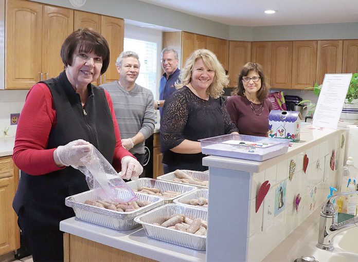 KITCHEN HELP: Providence Mutual employees volunteer to cook dinners for families at the Ronald McDonald House in Providence.  / COURTESY PROVIDENCE MUTUAL FIRE INSURANCE