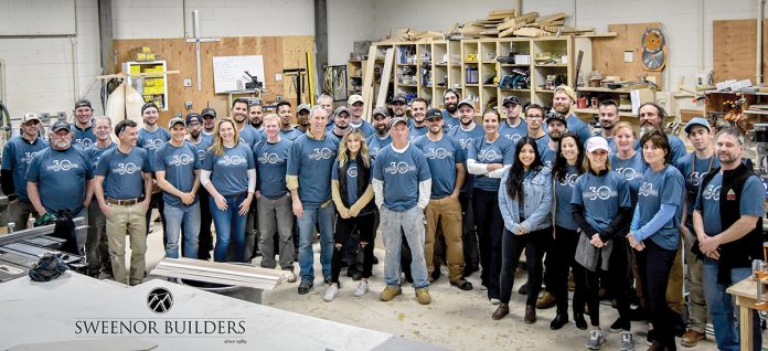 GROUP GATHERING: The staff of Sweenor Builders at the company workshop in the Wakefield section of South Kingstown.  / COURTESY SWEENOR BUILDERS