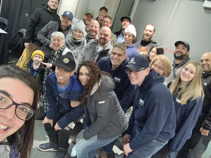 GAME FACES: Connectivity Point staff members, friends and relatives share a bonding moment at a Providence Bruins game.  / COURTESY CONNECTIVITY POINT DESIGN & INSTALLATION