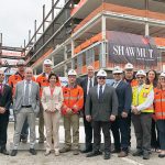 A HIGH POINT: Shawmut executives join local and state leaders and others for a topping-off ceremony for the River House Apartments in Providence.  / COURTESY SHAWMUT DESIGN AND CONSTRUCTION