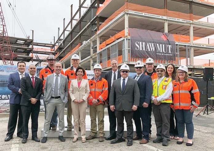 A HIGH POINT: Shawmut executives join local and state leaders and others for a topping-off ceremony for the River House Apartments in Providence.  / COURTESY SHAWMUT DESIGN AND CONSTRUCTION