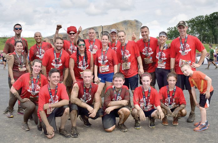 UP FOR A CHALLENGE: The Town Dock employees participate in an obstacle-course fundraiser called Warrior Dash last August.  / COURTESY THE TOWN DOCK