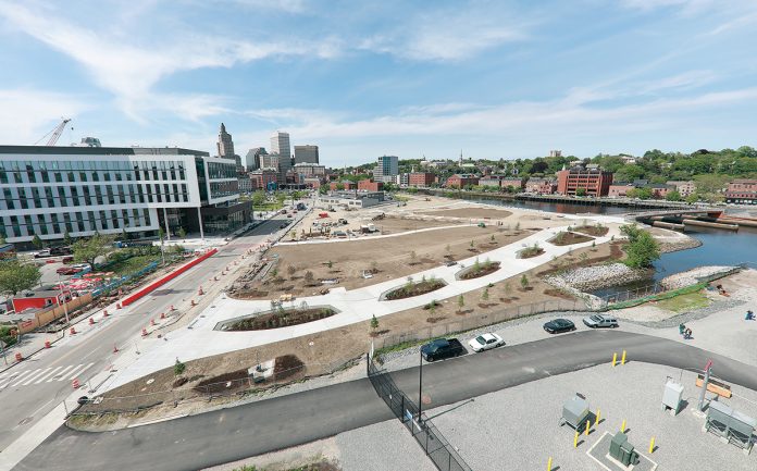 SLOW BUT SURE: The Wexford Science & Technology innovation center, left, and the public park, center, being built on the former I-195 land in Providence, are early pieces of the creation of a new neighborhood in the heart of Providence.  / PBN PHOTO/ARTISTIC IMAGES