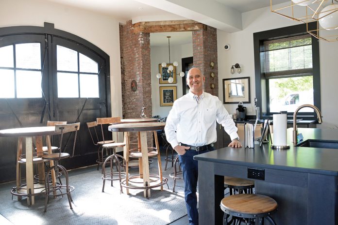 ANTIQUE FIREHOUSE: Christopher Bicho, owner of six boutique hotel properties in Newport, including the Town & Tide Inn, stands in a renovated, antique firehouse that he rents out as an Airbnb site.  / PBN PHOTO/ELIZABETH GRAHAM