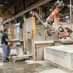 PRECISE CUTS: Bert Lima, shop supervisor at The Beck Cos., operates the robotic saw jet from BACA Systems. It allows precise cuts and details in the stone countertops and pieces that Beck manufactures.  / PBN PHOTO/MICHAEL SALERNO