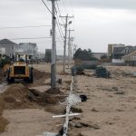 OVER 25,000 single-family homes are considered at-risk to be impacted by storm surge in the event of a Category 4 hurricane in Rhode Island. Above, a machine clears sand off Atlantic Avenue in Westerly after the remnants of Hurricane Sandy battered Rhode Island’s coast in 2012. / PBN FILE PHOTO/BRIAN MCDONALD