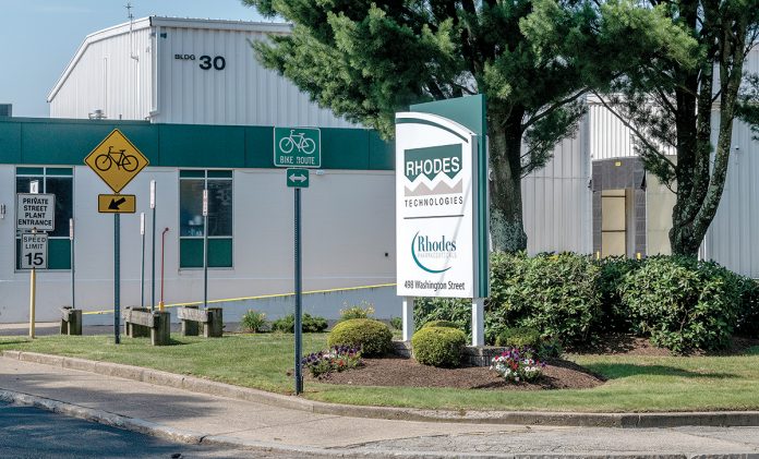 PURDUE SUBSIDIARY: Pictured above is a sign for the Rhodes Technologies plant complex at 498 Washington St. in Coventry. Rhodes is a subsidiary of Purdue Pharma, maker of prescription painkiller OxyContin, which is the subject of multiple lawsuits nationwide taking the drug manufacturer to task for the current “opioid epidemic.”  / PBN PHOTO/MICHAEL SALERNO