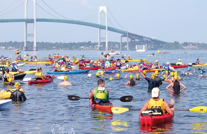 SWIM CHALLENGE: Swimmers and kayakers in the fourth wave of the 40th Save The Bay Swim get ready to traverse their course from Newport to Jamestown. The 43rd annual installment of the swim will be held July 27.  / COURTESY SAVE THE BAY INC.
