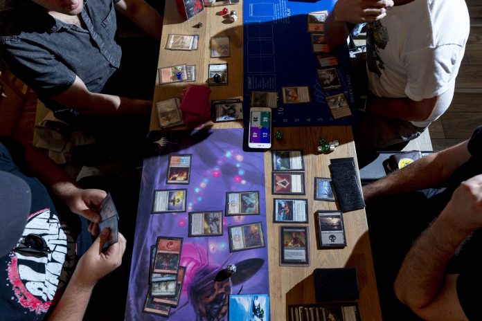 HASBRO IS LOOKING to grow its top and bottom lines with a decades-old game, Magic: The Gathering. But unlike tournaments in which players use paper cards, Hasbro has digitized the game and is informally naming it Arena. The company expects to be attracting millions of players in the next few years. / BLOOMBERG NEWS PHOTO/MARK ABRAMSON