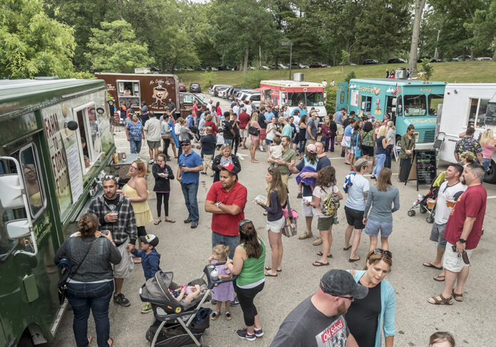 NEWPORT has voted to grant permits to food trucks and carts. Above, a crowd gathers at a Friday night food truck gathering at Roger Williams Park in Providence in 2016. / PBN FILE PHOTO/ MICHAEL SALERNO
