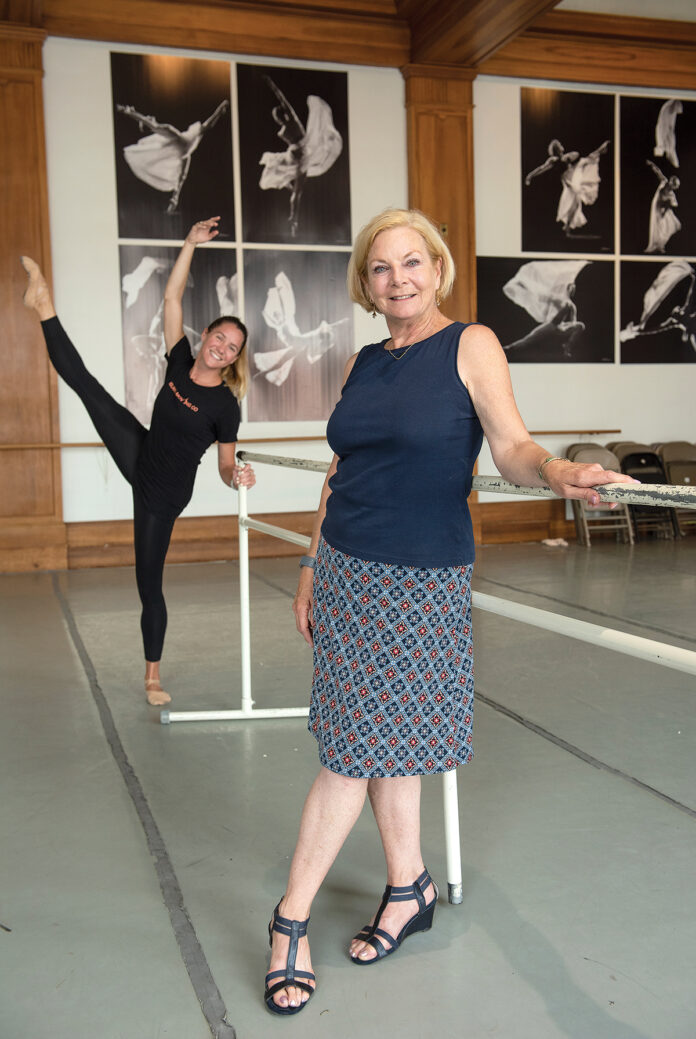 ON THE MOVE: Island Moving Company founder and Artistic Director Miki Ohlsen, with company dancer Emily Baker in the background. The ballet performance company is planning and fundraising for a new $4 million building that would include three studios as a black box theater and provide a home for its Newport Academy of Ballet.  / PBN PHOTO/DAVE HANSEN