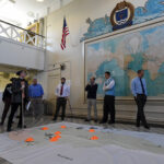U.S. NAVAL WAR College faculty members along with students from the Massachusetts Institute of Technology participate in a humanitarian response and disaster relief aid simulation during the MIT students’ visit to NWC’s Sims Hall. / COURTESY U.S. NAVY/MASS COMMUNICATION SPECIALIST 2ND CLASS JESS LEWIS