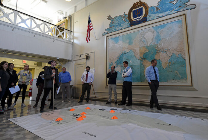 U.S. NAVAL WAR College faculty members along with students from the Massachusetts Institute of Technology participate in a humanitarian response and disaster relief aid simulation during the MIT students’ visit to NWC’s Sims Hall. / COURTESY U.S. NAVY/MASS COMMUNICATION SPECIALIST 2ND CLASS JESS LEWIS