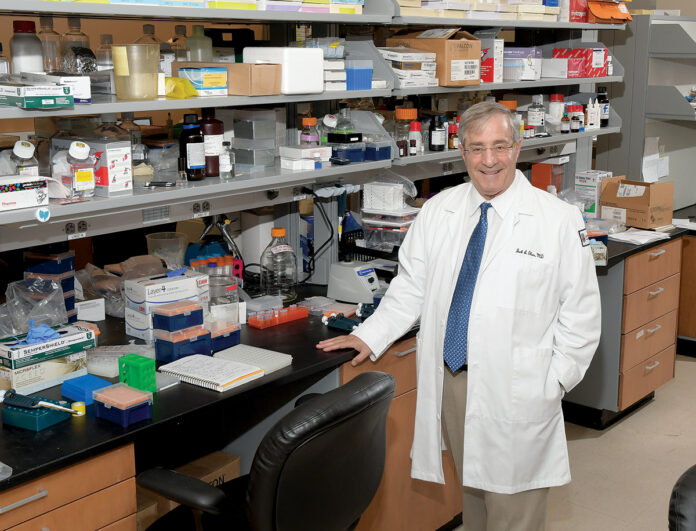 LAB WORK: Dr. Jack A. Elias, a top administrator at Brown University’s Warren Alpert Medical School, is also considered a leader in research designed to be put to use in doctors’ offices and hospitals to improve health outcomes.  / PBN PHOTO/MIKE SKORSKI