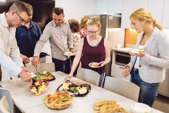 DIGGING IN: Members of the CBIZ staff select fruits and vegetables during healthy snack day at the Providence office. From left are Patrick Quinn, CBIZ managing director; John Boyle, audit associate; Jeffrey Christina, intern; Monica Clark, executive assistant; and Annie Campbell, audit associate.  / PBN PHOTO/RUPERT WHITELEY