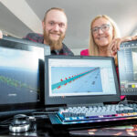 A MODEL COMPANY: Thomas Steere, a 3D computer-aided design specialist, left, and his mother, Patricia Steere, president of Steere Engineering Inc., display a virtual-reality rendering of the Mount Hope Bridge, and a computer-aided design model of the Sumner Tunnel in Boston, in the firm’s Warwick office. PBN PHOTO/DAVE HANSEN