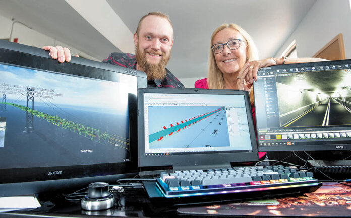 A MODEL COMPANY: Thomas Steere, a 3D computer-aided design specialist, left, and his mother, Patricia Steere, president of Steere Engineering Inc., display a virtual-reality rendering of the Mount Hope Bridge, and a computer-aided design model of the Sumner Tunnel in Boston, in the firm’s Warwick office. PBN PHOTO/DAVE HANSEN