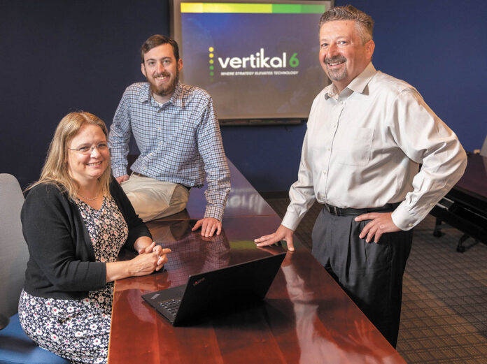 MEETING OF MINDS: Vertikal6 CEO Rick Norberg, right, with applications developer James Green and senior consultant Meredith Carroll. PBN PHOTO/DAVE HANSEN