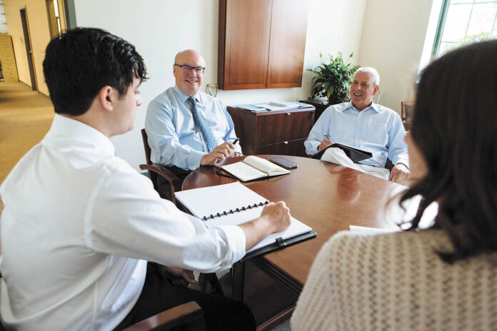 LENDING A HAND: Staff members at Rhode Island Infrastructure Bank gather to discuss agency business. From left is Business Development Analyst Graeme Ownjazayeri, CEO and Executive Director Jeffrey Diehl, Chief Operating Officer David Birkins and Senior Business Development Analyst Sydney Usatine. PBN PHOTO/RUPERT WHITELEY