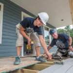 PITCHING IN: MetLife employees Haley Cuddy, left, senior marketing research consultant, and Tim Bowen, assistant vice president, claims, work on a new house in Exeter for a project overseen by South County Habitat for Humanity.  / PBN PHOTO/MICHAEL SALERNO
