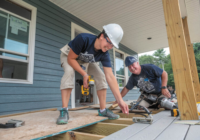 PITCHING IN: MetLife employees Haley Cuddy, left, senior marketing research consultant, and Tim Bowen, assistant vice president, claims, work on a new house in Exeter for a project overseen by South County Habitat for Humanity.  / PBN PHOTO/MICHAEL SALERNO