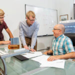EFFICIENCY EXPERTS: Aquanis Inc. CEO Neal E. Fine, right, Chief Technology Officer John A. Cooney, center, and Senior Mechanical Engineer Christopher Szlatenyi are working on turbine blade designs that would make them more efficient. PBN PHOTO/DAVE HANSEN