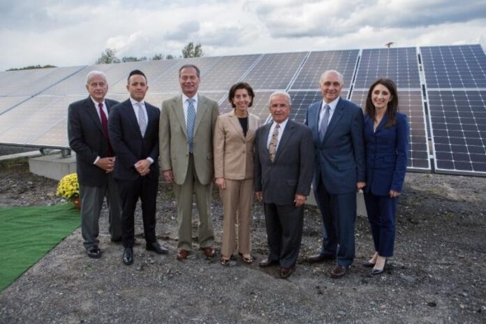 Southern-Sky-Renewable-RI-and-leaders SOUTHERN SKY RENEWABLE ENERGY President Ralph Palumbo, second from right, voluntarily withdrew a no-bid contract this week with the city of Cranston. He is pictured here with, from left, North Providence Chief of Staff Richard Fossa, North Providence Town Council President Dino Autiello, R.I. Senate President Dominick J. Ruggiero, Gov. Gina M. Raimondo, North Providence Mayor Charles Lombardi, and Southern Sky Vice President Lindsay McGovern. They gathered in October at a Southern Sky solar panel array in North Providence. / COURTESY SOUTHERN SKY RENEWABLE ENERGY