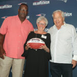 FOUNDING MEMBER: Esta Cohen, center, a founding member of the Dress for Success Providence board of directors, receives her 2019 Myra Kraft Community MVP Award. Pictured with Cohen are New England Patriots Foundation Executive Director of Community Affairs Andre Tippett, left, and New England Patriots Chairman and CEO Robert Kraft.  / COURTESY ERIC J. ADLER