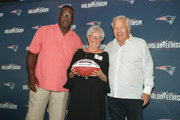 FOUNDING MEMBER: Esta Cohen, center, a founding member of the Dress for Success Providence board of directors, receives her 2019 Myra Kraft Community MVP Award. Pictured with Cohen are New England Patriots Foundation Executive Director of Community Affairs Andre Tippett, left, and New England Patriots Chairman and CEO Robert Kraft.  / COURTESY ERIC J. ADLER