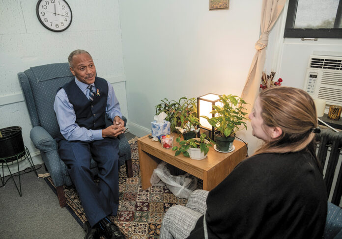 DIALOGUING: Robert Samuels, director of the University of Rhode Island counseling center, talks with Ashley O’Hearn, a graduate student trainee at the center. / PBN PHOTO/MICHAEL SALERNO