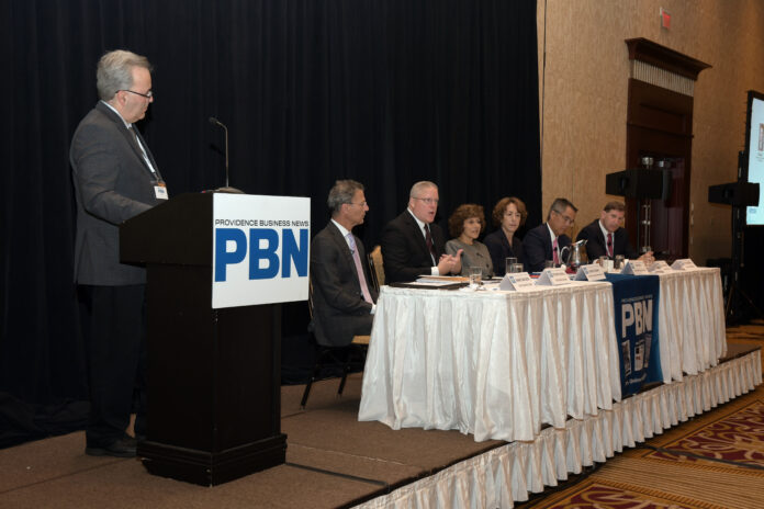 PROVIDENCE BUSINESS NEWS EDITOR Mike Mello, left, leads the discussion at PBN's Health Care Summit on Wednesday. Participating on the panel are, from left, Marc Backon, president, commercial division, at Tufts Health Plan; Stephen Farrell, CEO of UnitedHealthcare of New England; Marie L. Ganim, R.I. Health Insurance Commissioner, Kim A. Keck, CEO and president of Blue Cross & Blue Shield of Rhode Island; Dr. Alan Kurose, CEO and president of Coastal Medical; and Neil D. Steinberg, CEO and president of Rhode Island Foundation. / PBN PHOTO/MIKE SKORSKI