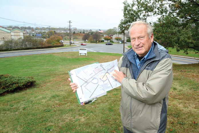 STANDSTILL: John Hirschboeck, co-president of community nonprofit Alliance for a Livable Newport, argued for a six-month development moratorium in the city’s North End. He and other supporters say the city needs time to develop zoning requirements for the area, shown on the map he’s holding. / PBN PHOTO/DAVE HANSEN