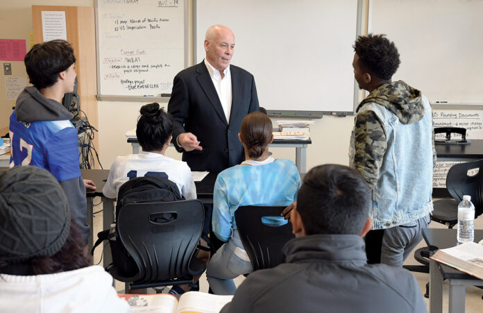LIFE SKILLS: Stephen Cronin, a sales executive with Signature Printing in East Providence, volunteers at Hope High School in Providence, teaching students interpersonal and research skills desired by employers. / PBN PHOTO/MIKE SKORSKI