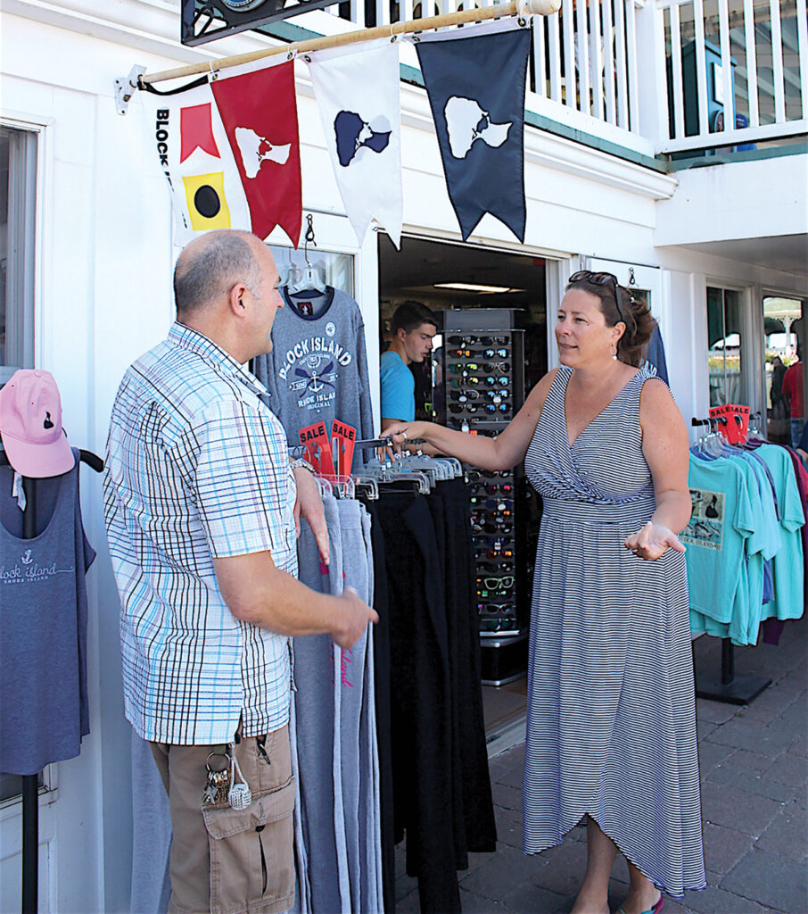 LIMITED RESOURCES: Block Island Tourism Council Executive Director Jessica K. Willi, talking with John Cullen, owner of B.I. Tees, says her group is examining the best ways to increase tourism revenue while keeping summer visitations to the island under control. / PBN FILE PHOTO/K. CURTIS