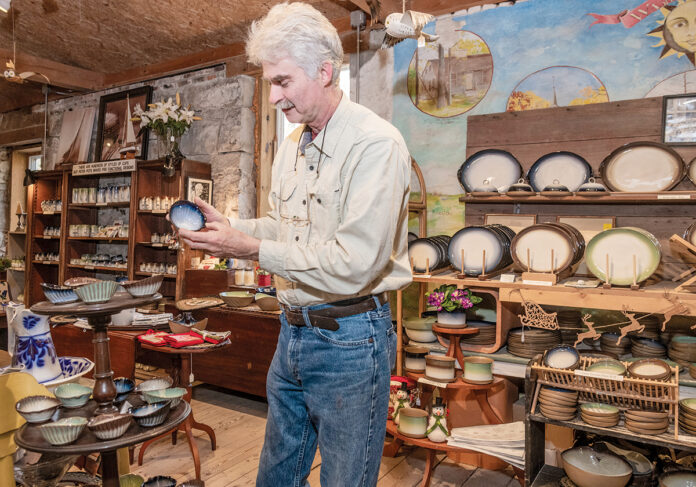 CRAFTY FELLOW: Jeffrey Greene, owner of Peter Pots Pottery, displays some of the pottery products he and his craftspeople have made by hand at a converted old mill in South Kingstown. / PBN PHOTO/MICHAEL SALERNO