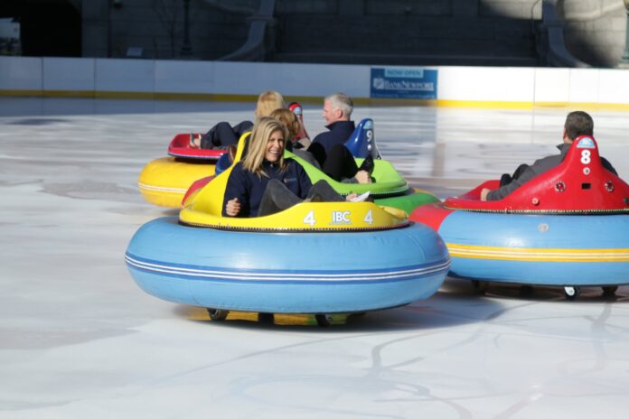 WENDY KAGAN, executive vice president and director of employee and community engagement at BankNewport, rides one of the ice bumper cars at the Providence Rink, which was recently renamed as the BankNewport City Center – Providence Rink after the bank purchased the naming rights. / COURTESY CITY OF PROVIDENCE