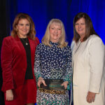 KRISTEN ADAMO, left, and Kimberly Greene, right, induct Karen Silva, department chair of graduate business programs at Johnson & Wales University, into the PWCVB Hall of Fame. / PROVIDENCE WARWICK CONVENTION & VISITORS BUREAU