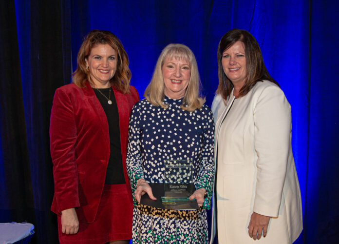 KRISTEN ADAMO, left, and Kimberly Greene, right, induct Karen Silva, department chair of graduate business programs at Johnson & Wales University, into the PWCVB Hall of Fame. / PROVIDENCE WARWICK CONVENTION & VISITORS BUREAU