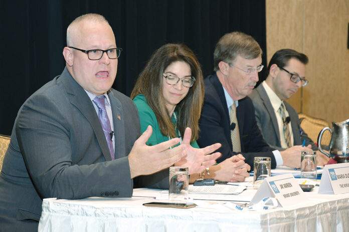 NOT LIABLE: Bryant University Physician Assistant Program founder and Director Robert Jay Amrien, left, a panelist at the PBN Fall Health Care Summit, says a new law declaring that a physician assistant may be considered a primary care provider means a physician would not be considered liable for the actions of a physician assistant. Next to Amrien, from left, are panelists Maria Ducharme, chief nursing officer and senior vice president of patient care services at The Miriam Hospital; Care New England CEO Dr. James E. Fanale; and James Rajotte, chief of the Center for Health Promotion in the Division of Community Health and Equity at the R.I. Department of Health. / PBN PHOTO/MIKE SKORSKI NOT LIABLE: Bryant University Physician Assistant Program founder and Director Robert Jay Amrien, left, a panelist at the PBN Fall Health Care Summit, says a new law declaring that a physician assistant may be considered a primary care provider means a physician would not be considered liable for the actions of a physician assistant. Next to Amrien, from left, are panelists Maria Ducharme, chief nursing officer and senior vice president of patient care services at The Miriam Hospital; Care New England CEO Dr. James E. Fanale; and James Rajotte, chief of the Center for Health Promotion in the Division of Community Health and Equity at the R.I. Department of Health. / PBN PHOTO/MIKE SKORSKI