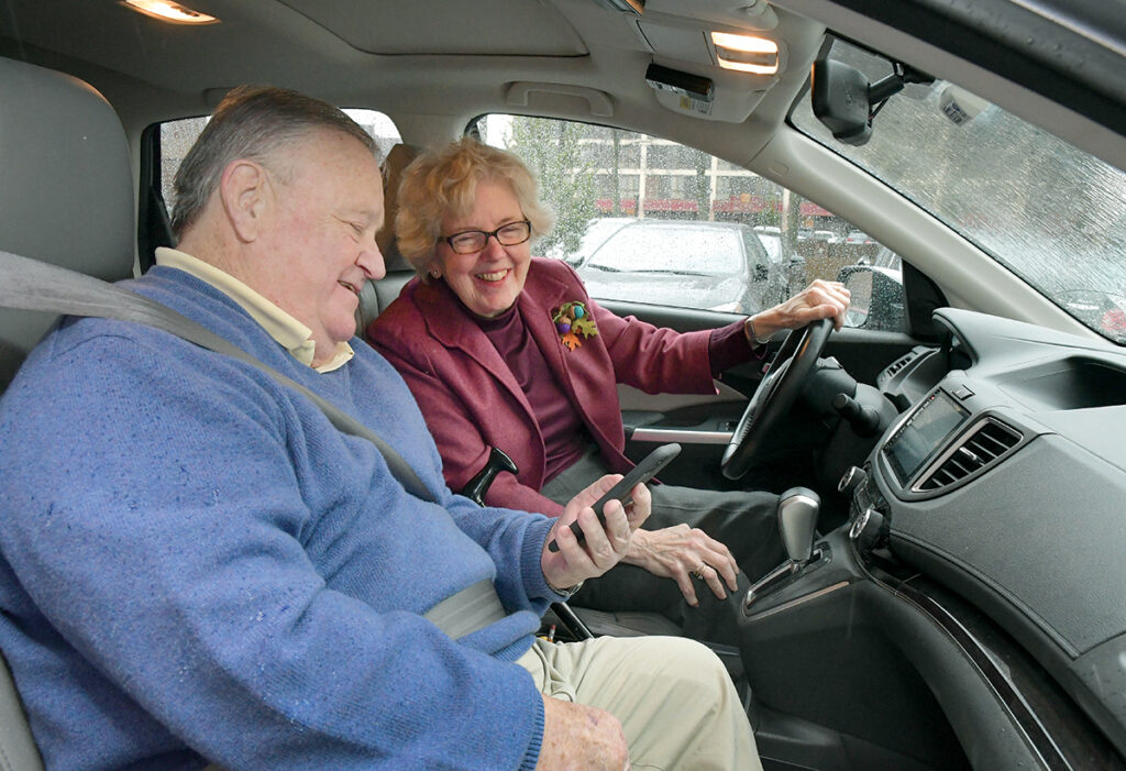 HELPING HAND: Anne Connor picks up Joe Santarlasci, a retiree who is benefiting from The Village Common of Rhode Island, which aims to connect seniors with volunteer services. Connor is a volunteer and helps Santarlasci by giving him rides to receive dialysis treatment.  / PBN PHOTO/MIKE SKORSKI