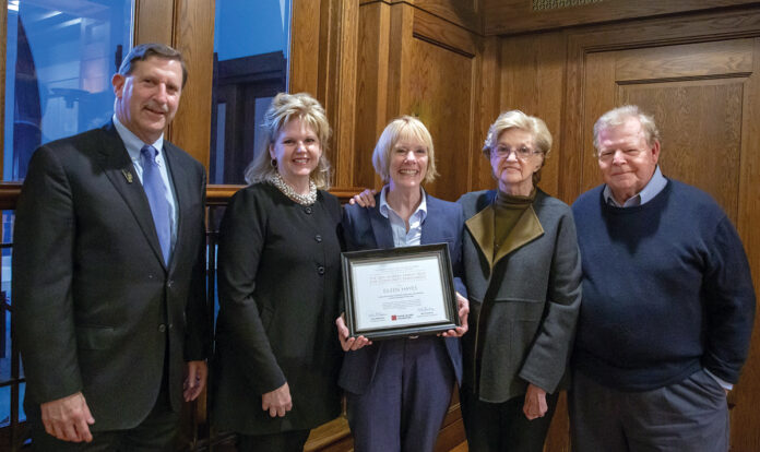 ENRICHING LIVES: Eileen Hayes, center, CEO and president of Amos House, receives the 2019 Murray Family Prize for Community Enrichment from the Rhode Island Foundation. Pictured with Hayes, from left, are Rhode Island Foundation CEO and President Neil D. Steinberg, Paula McNamara, Suzanne Murray and Terry Murray of the Murray family, which created the award. / COURTESY RHODE ISLAND FOUNDATION