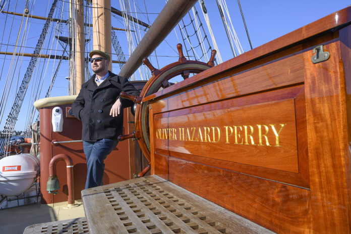 SETTING A HEALTHY COURSE: Oliver Hazard Perry Rhode Island CEO Jonathan Kabak on the deck of the nonprofit’s Tall Ship in Newport. Kabak says the organization has never offered health insurance coverage to its workers, but he said it’s an important part of employees contributing to the company and it will help with recruitment. / PBN PHOTO/DAVE HANSEN  
