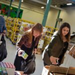 VOLUNTEERS SORT items at the Rhode Island Community Food Bank, one of seven social service agencies sharing $180,000 in emergency year-end grants from the Rhode Island Foundation. / COURTESY CONNIE GROSCH/RHODE ISLAND FOUNDATION