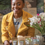 TEA IT UP: Amber Jackson with some of the products available through her business, Black Leaf Tea and Culture Shop. / PBN PHOTO/MICHAEL SALERNO