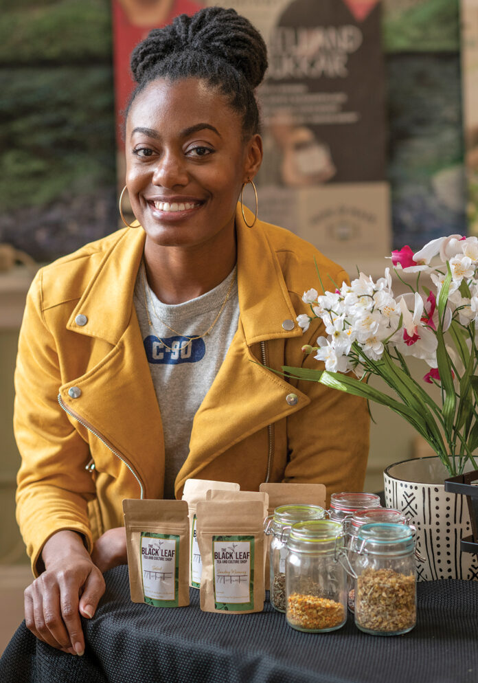 TEA IT UP: Amber Jackson with some of the products available through her business, Black Leaf Tea and Culture Shop. / PBN PHOTO/MICHAEL SALERNO