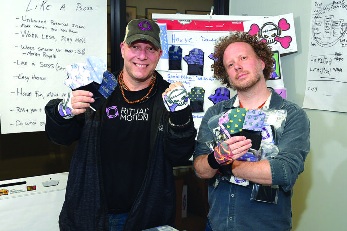 WARRIOR SKINS: Dana Paul, left, CEO of Ritual Motion in Warwick, and Fred Tindall, director of production, show off the company’s new gloves to help competitive video game players prevent injuries from repetitive hand motions. / PBN PHOTO/MIKE SKORSKI WARRIOR SKINS: Dana Paul, left, CEO of Ritual Motion in Warwick, and Fred Tindall, director of production, show off the company’s new gloves to help competitive video game players prevent injuries from repetitive hand motions. / PBN PHOTO/MIKE SKORSKI